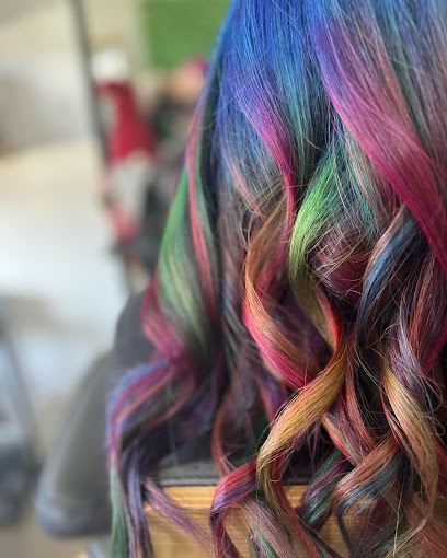 Long curled hair coloured in vivid blue, green, pink and gold