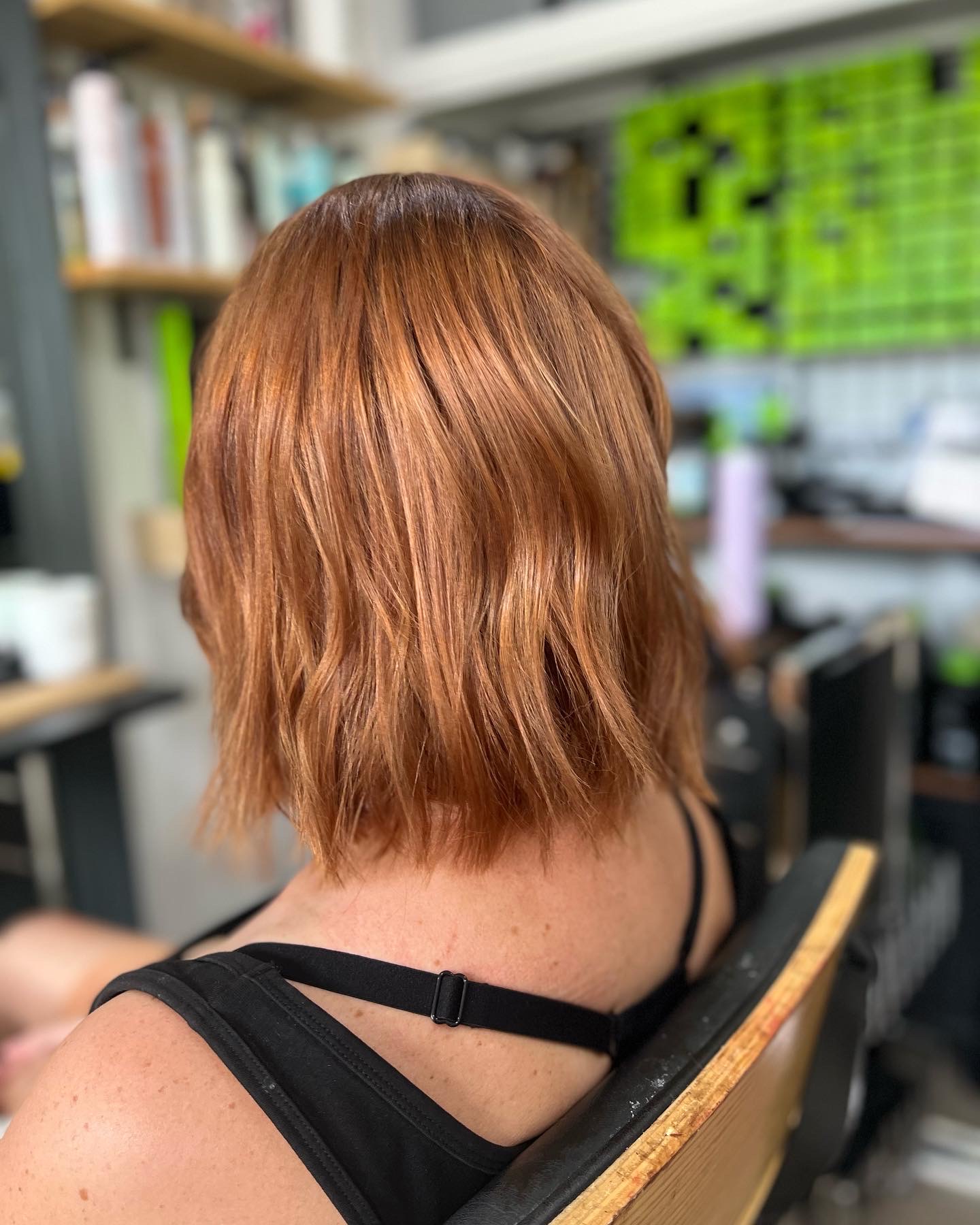 A copper textured bob, photographed in Coral's studio with product shelves behind